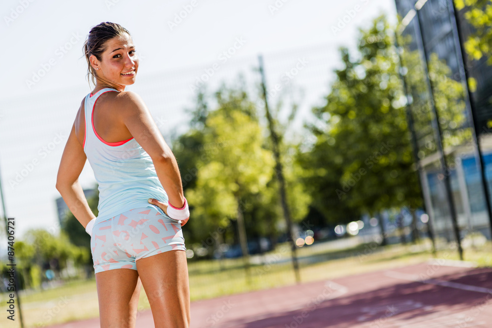 Beautiful young woman smiling during exerice outdoors Beautiful young woman smiling during exerice outdoors