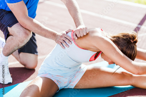 Trainer helping during strech out