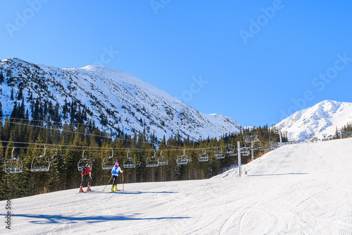 Alpine skiers on slope in Rohace winter resort, Tatra Mountains, Slovakia