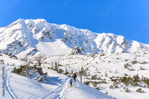 Alpine skiers on on winter trail in Rohace valley, Tatra Mountains, Slovakia