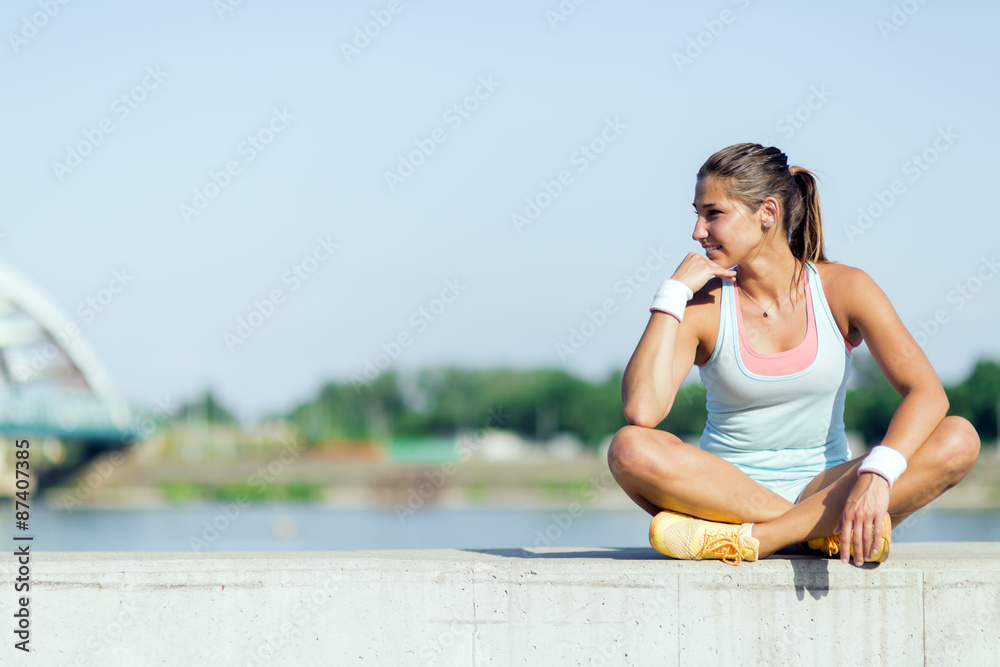 Young woman stretching and relaxing in the city