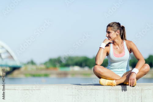 Young woman stretching and relaxing in the city