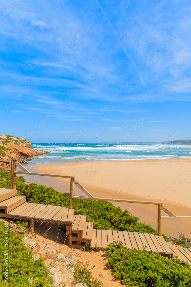 Wooden walkway to Praia do Bordeira beach and beautiful blue sea, Algarve region, Portugal