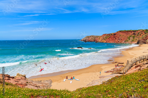 Surfers on Praia do Amado beach and beautiful blue sea, Algarve region, Portugal © pkazmierczak