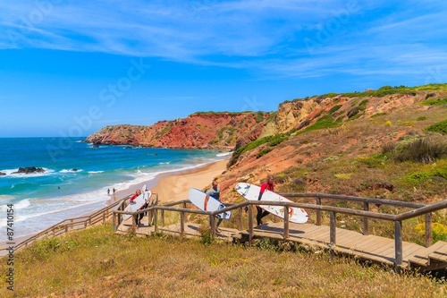 Photography Surfers walking on footbridge from beautiful beach in Algarve region