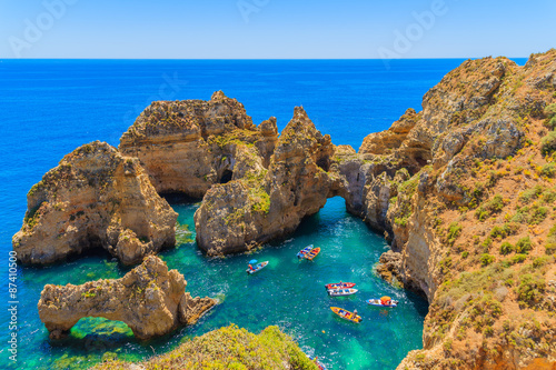 Fishing boats on turquoise sea water at Ponta da Piedade, Algarve region, Portugal