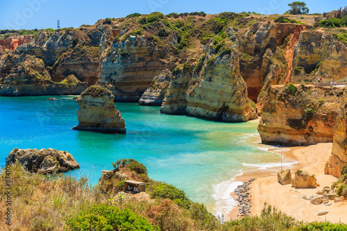 View of famous Praia Dona Ana beach with turquoise sea water and cliffs, Portugal © pkazmierczak