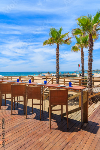 Chairs on terrace of a restaurant on Armacao de Pera beach in Algarve region  Portugal