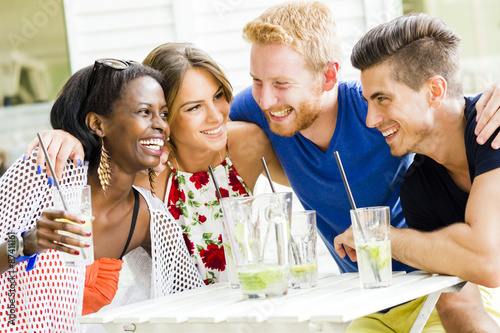 Happy young people laughing a being happy at a table