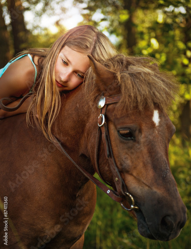 Portrait of a beautiful girl on horseback