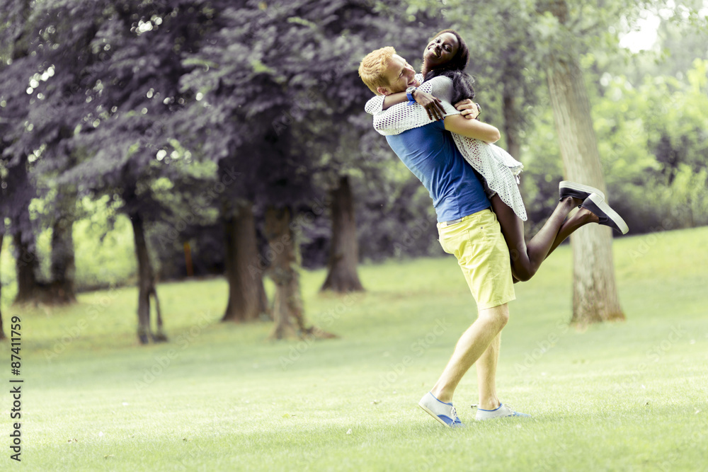 Portrait of a happy couple dancing and hugging in nature outdoor