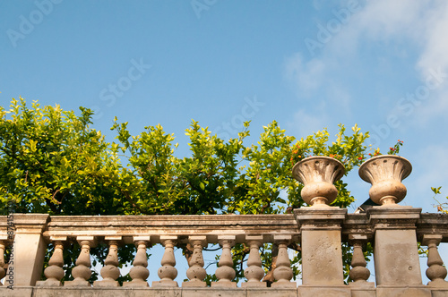 Partial view of the balustrade and of the garden laying by the episcopal palace in Syracuse