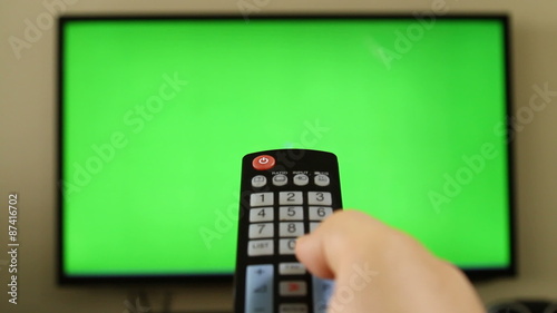 POV holding remote control with green screen inside tv LED screen