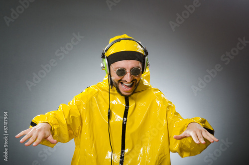 Man wearing yellow suit listening to headphones © Elnur