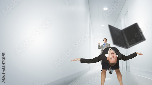 Two business people fighting with each other