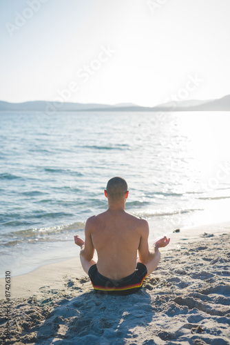 young handsome sporty man making yoga