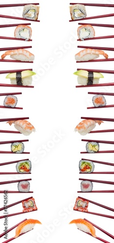 Many different sushi and rolls in chopsticks isolated on white background