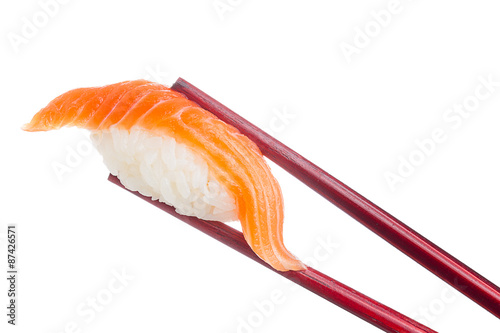 Salmon sushi nigiri in chopsticks isolated on white background