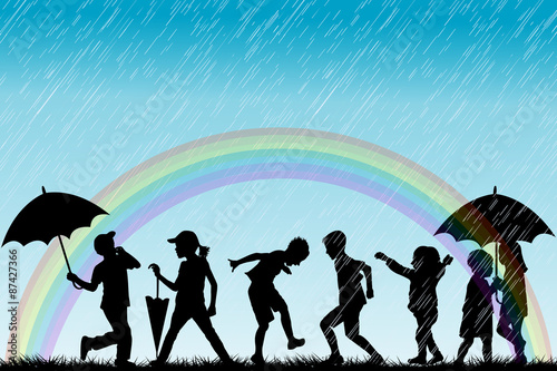 Children silhouettes enjoy the rain