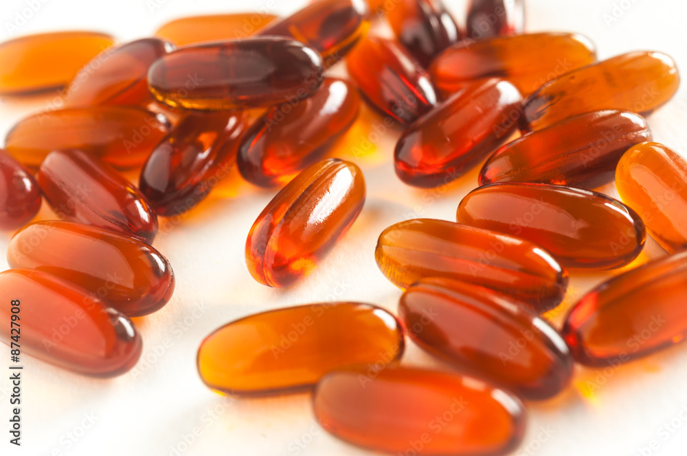 Vitamin in capsule on white Vitamin in capsule on white