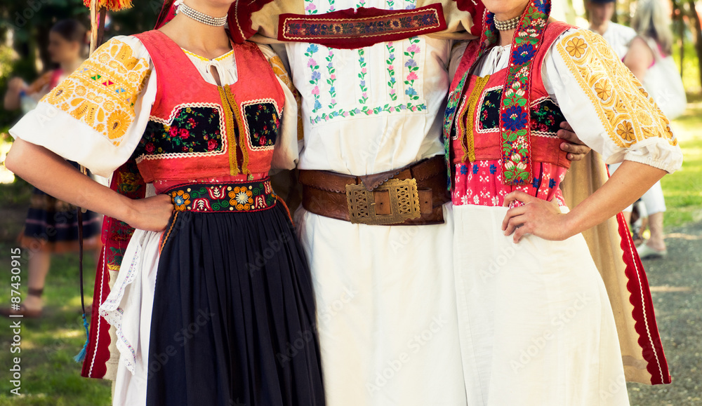 Anonymous young people in folklore costumes