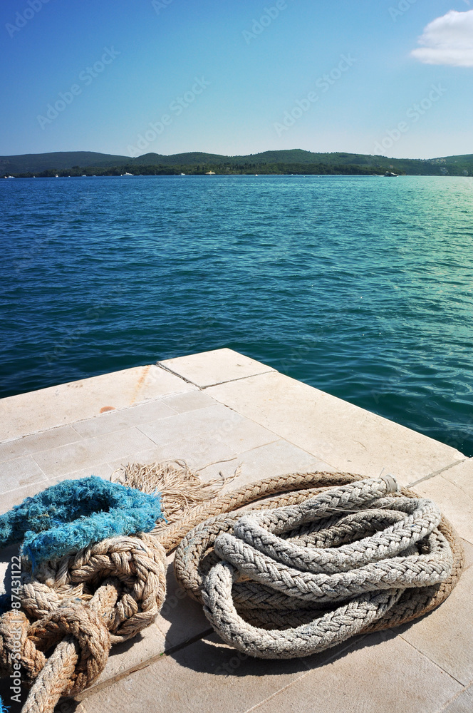 Fototapeta premium Old iron mooring mast and ropes