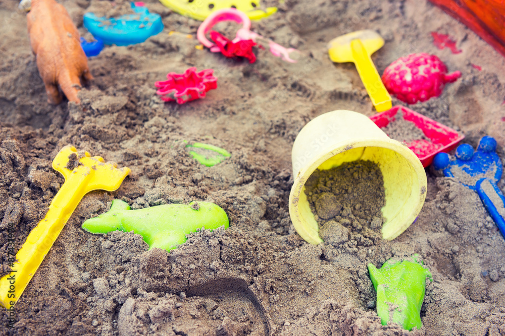 Plastic children toys in sandpit or on a beach Plastic children toys in sandpit or on a beach