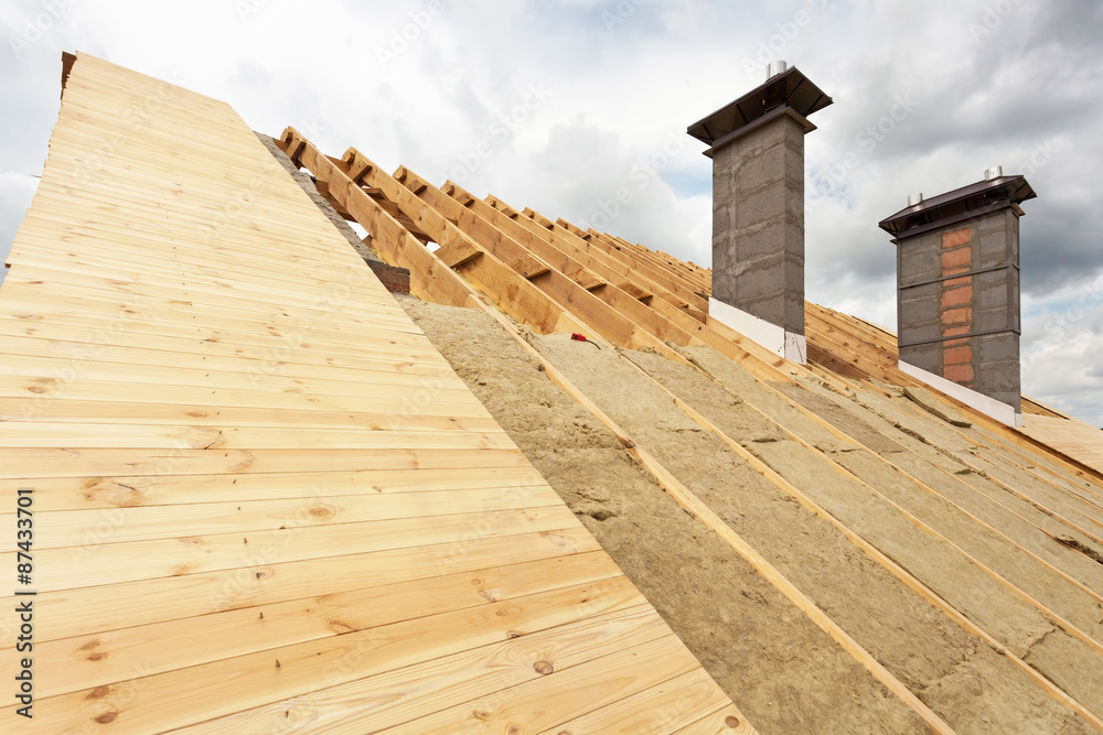 Fototapeta premium Chimneys on a wooden roof under construction