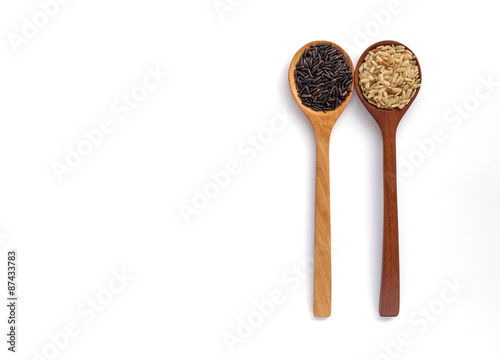 Rice and wooden spoon with space on white background