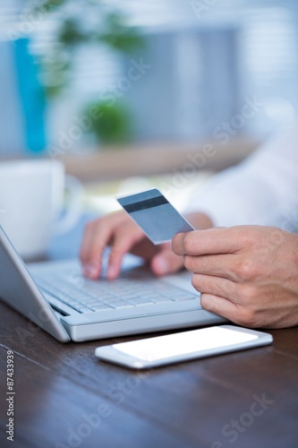 Close up view of a businessman using a credit card