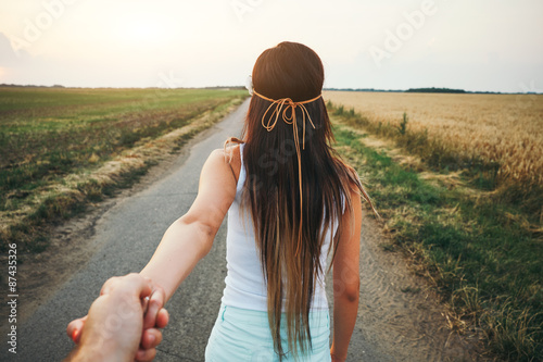 Young woman leading man photo