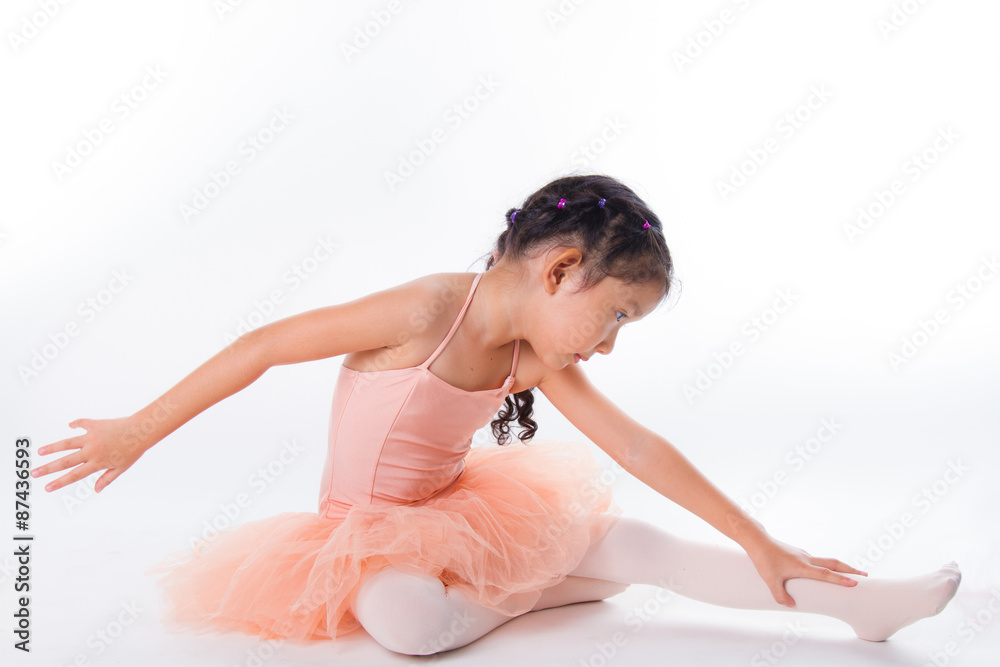 Fototapeta premium A little ballerina in the studio. On White Background