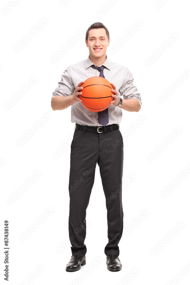 Fototapeta premium Young businessman holding a basketball