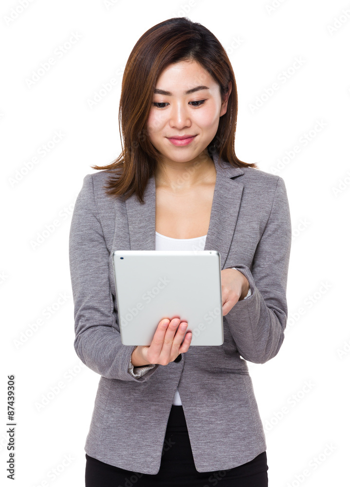 Asian young businesswoman use of the tablet pc Asian young businesswoman use of the tablet pc