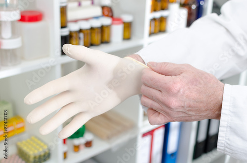 Doctor putting on a latex glove