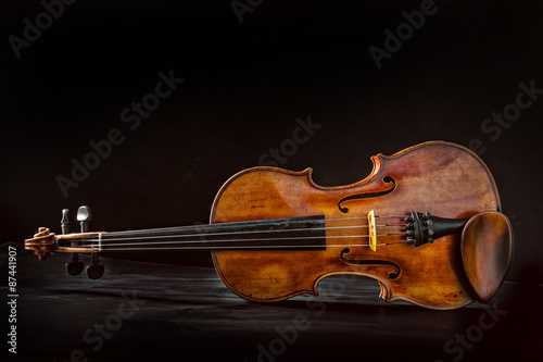 Old violin on dark background.