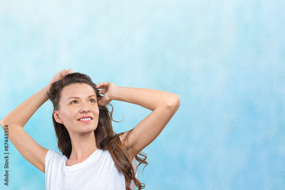 Fototapeta premium Happy young woman on blue background