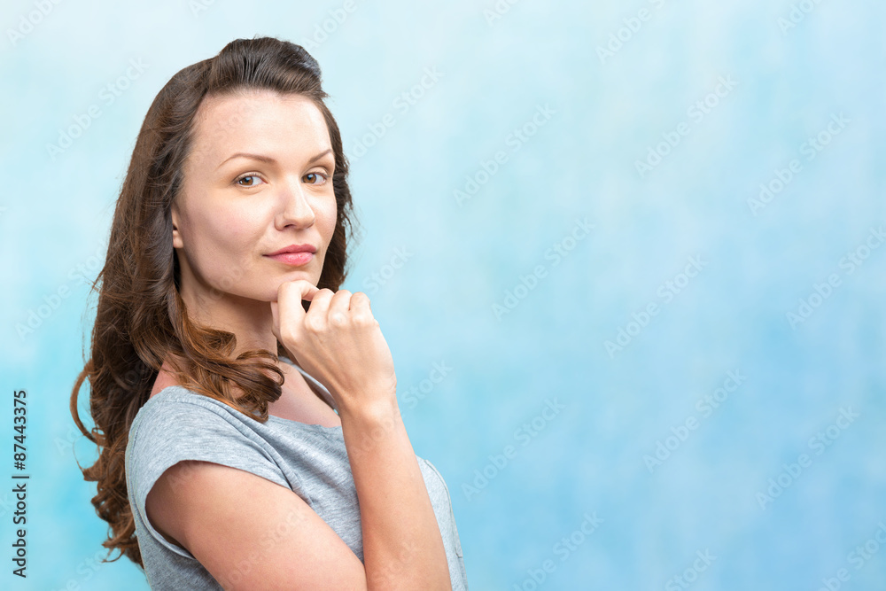 Fototapeta premium Happy young woman on blue background
