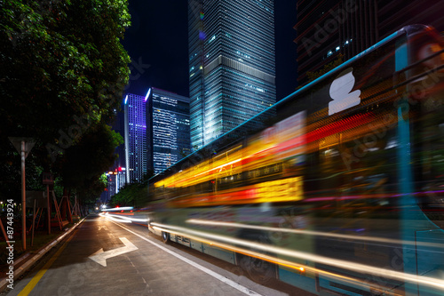 Busy traffic light trails and office buildings.