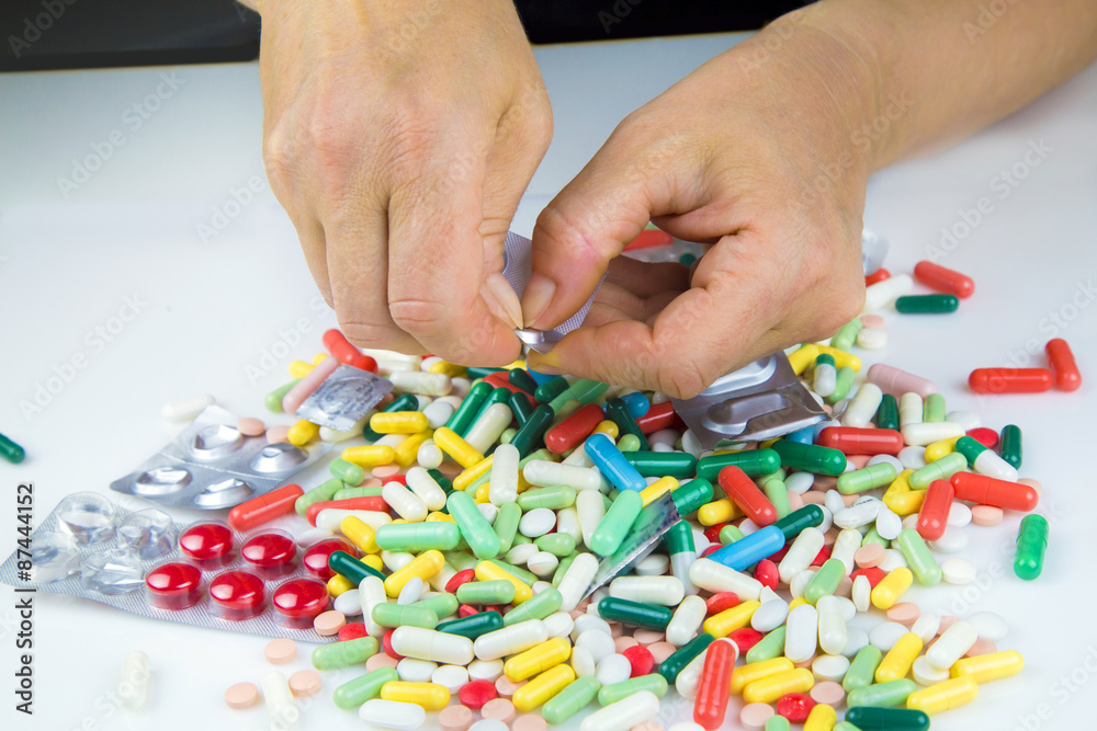 Hands holding a lot of pills Hands holding a lot of pills