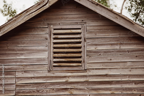 Closeup image of top of wooden house with vintage roof 