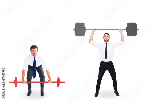 Businessmen lifting barbells over head