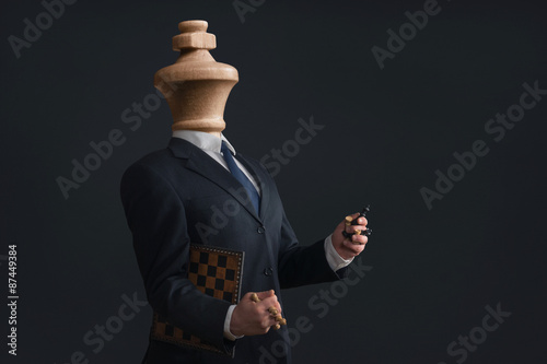 Symbol of a narcissist without head and with pawns in the hands photo