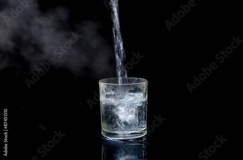 Pouring hot water into glass