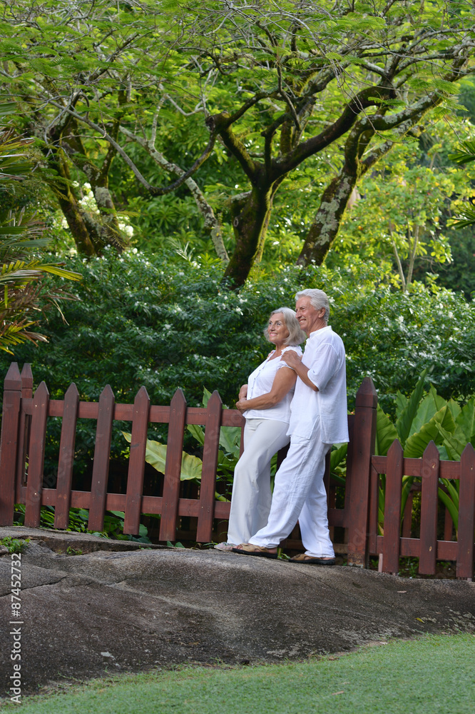 Elderly couple in tropical garden Elderly couple in tropical garden