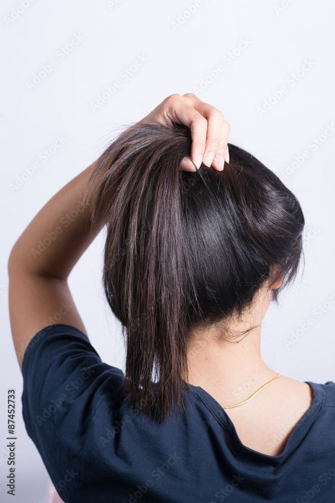 Asian woman braiding hair. Asian woman braiding hair.