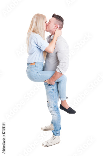 Man holding woman by legs with his strong arms