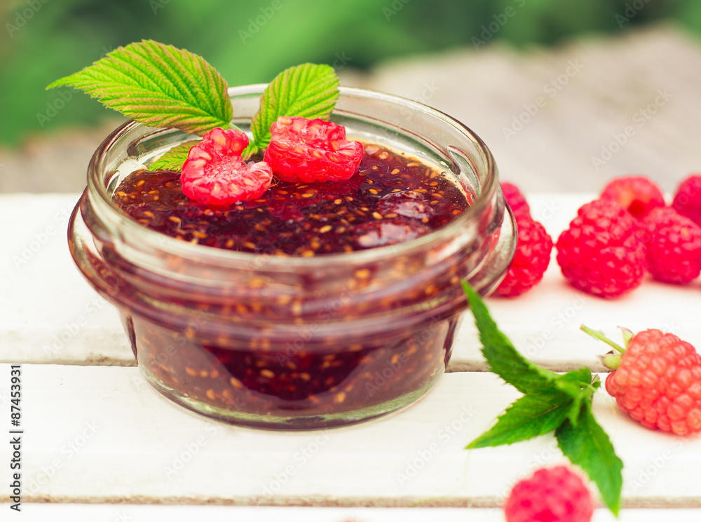 raspberry jam in a jar and fresh berries on the wooden table raspberry jam in a jar and fresh berries on the wooden table