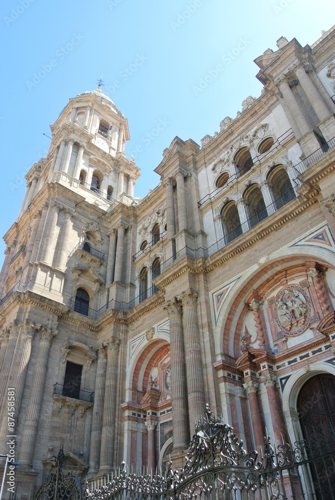 Facade of Malaga Cathedral, one of the major tourist attractions of Malaga, built in renaissance style, on a sunny summer day.