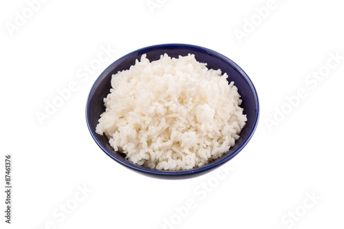 Cooked steamed rice in a blue bowl over white background